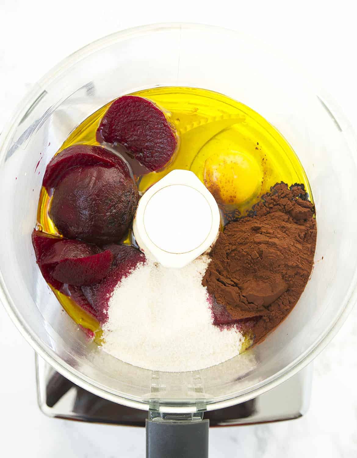 Beetroots, egg, sugar, oil and cocoa powder into a food processor bowl.