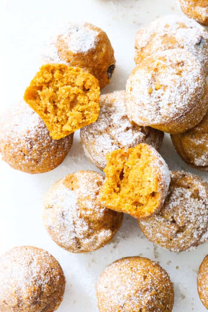 Mini pumpkin muffins on a white background.