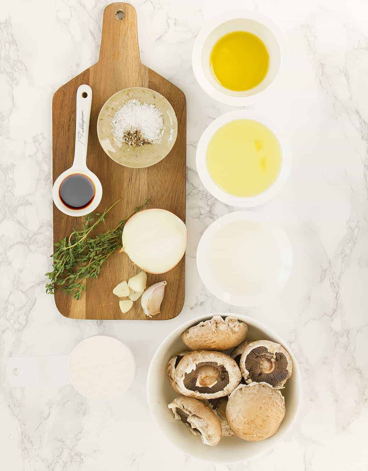The ingredients for this healthy mushroom soup are arranged over a white background.
