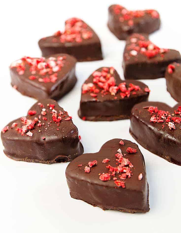 Seven vegan chocolate hearts over a white background - The Clever Meal: 
