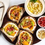 Assortment of vegan appetizers on a black round tray.