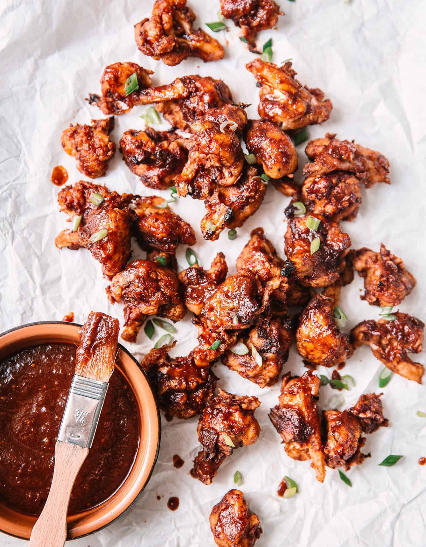 BBQ cauliflower wings on white parchment paper - The Green Life