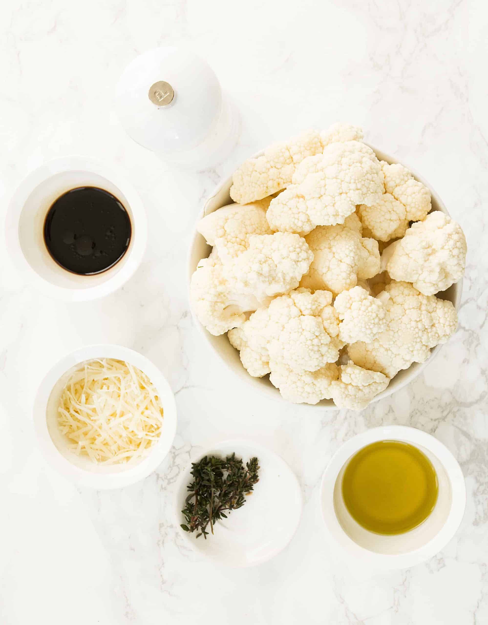 The ingredients for the roasted balsamic cauliflower are arranged over a white background.