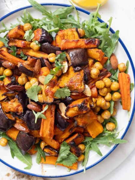 Harissa eggplant carrot salad with chickpeas and arugula.