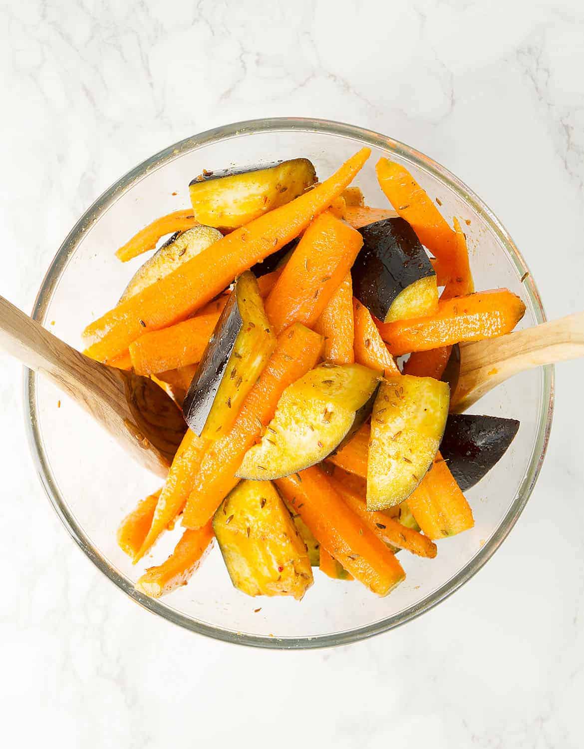 Carrot and eggplant mixed in a glass container.