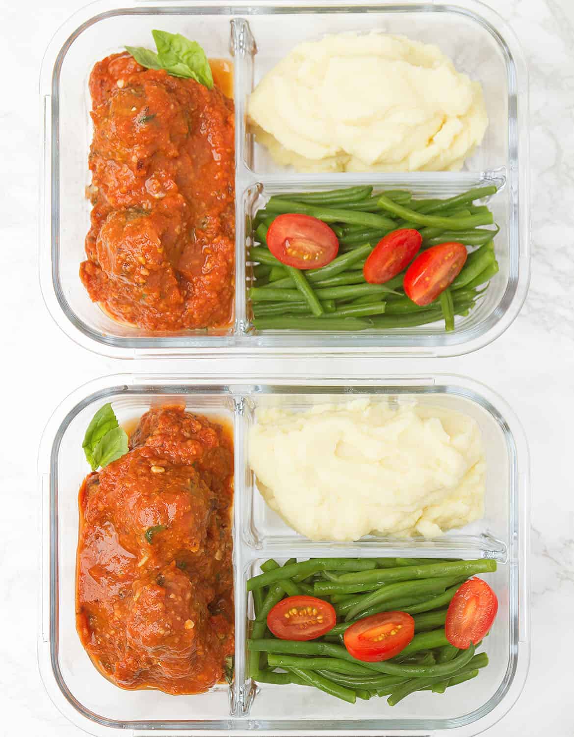 vegan meatballs in meal prep containers with mashed potatoes and green beans.