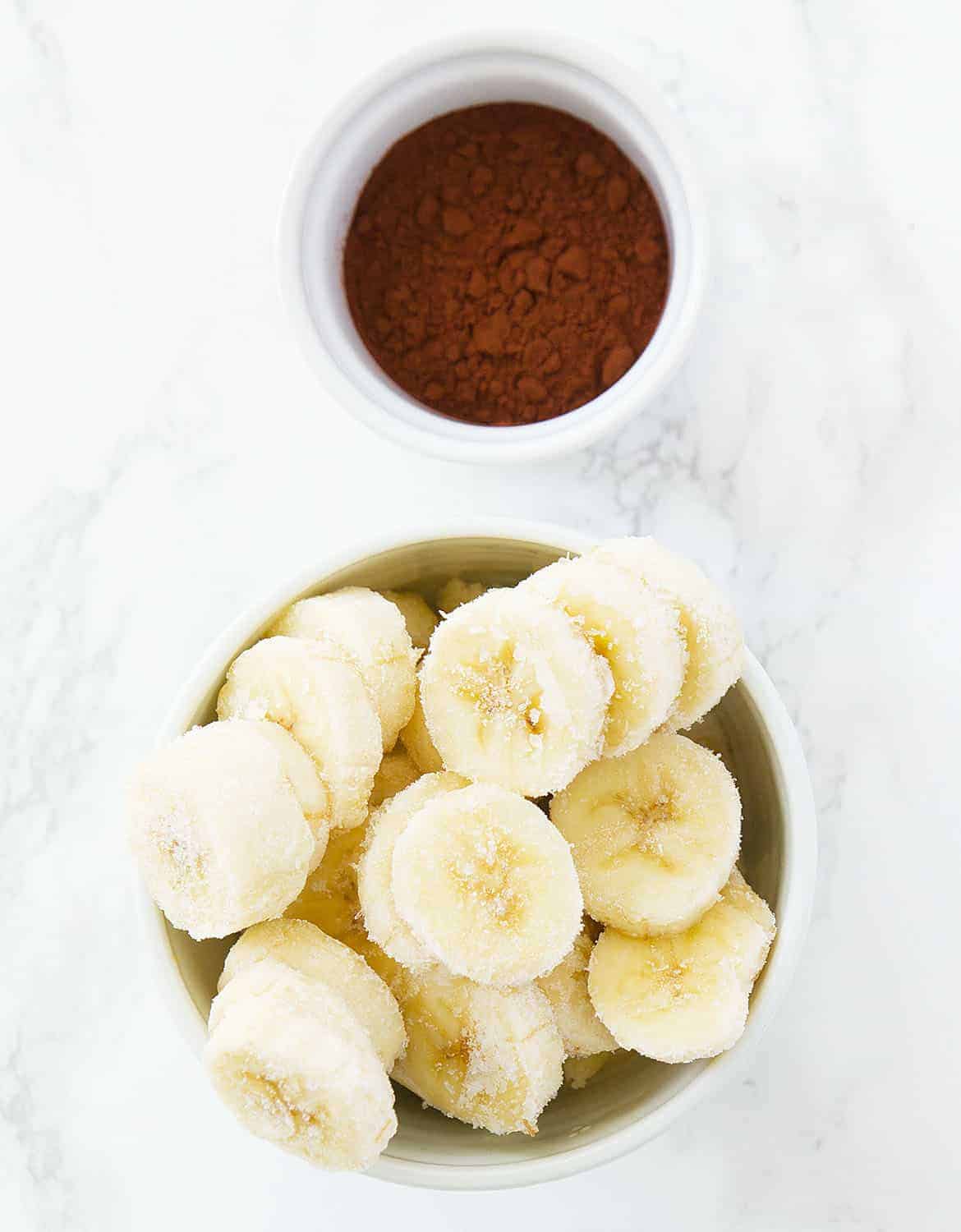 The ingredients for this chocolate banana ice cream are arranged over a white background.