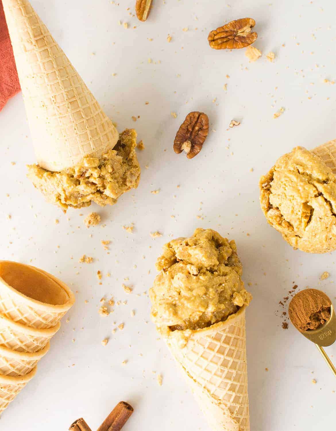 Vegan pumpkin ice cream with cones over a white background - Mindful Avocado