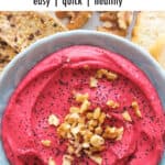 Top view of a blue bowl with beetroot hummus.