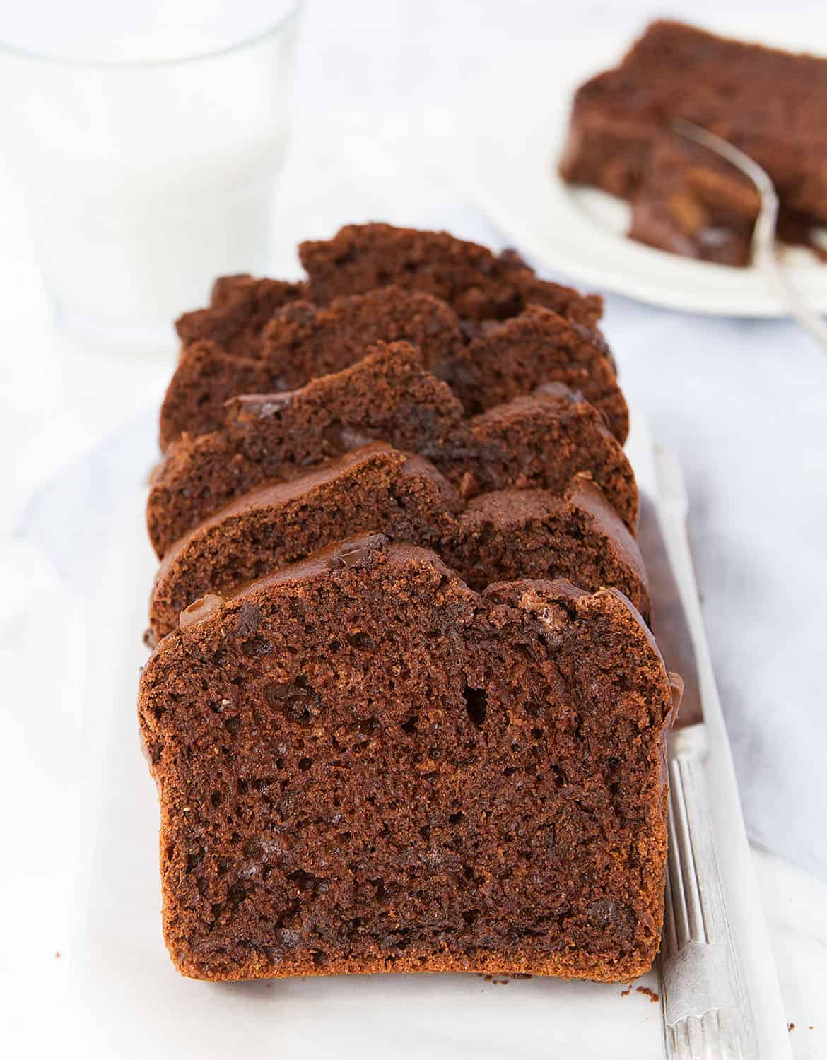 Five slices of healthy chocolate zucchini bread on a white tray - The Clever Meal