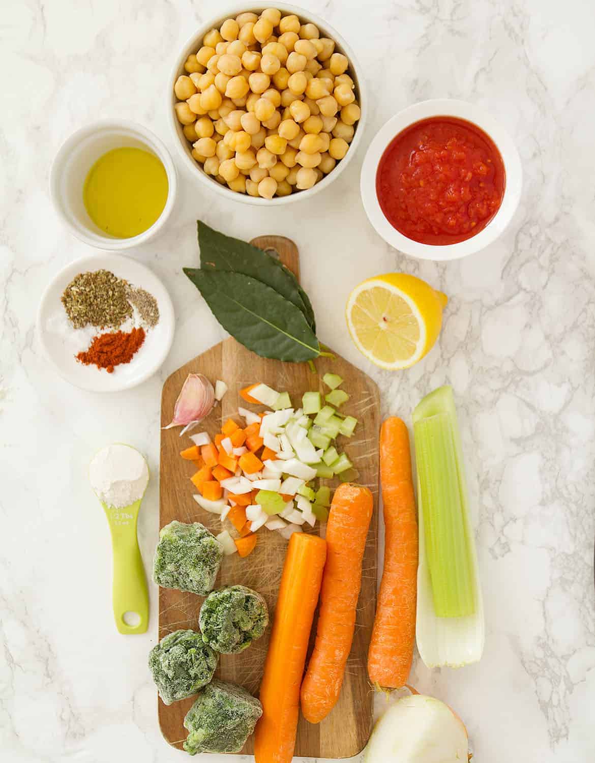 The ingredients for this Mediterranean chickpea soup are arranged over a white background.