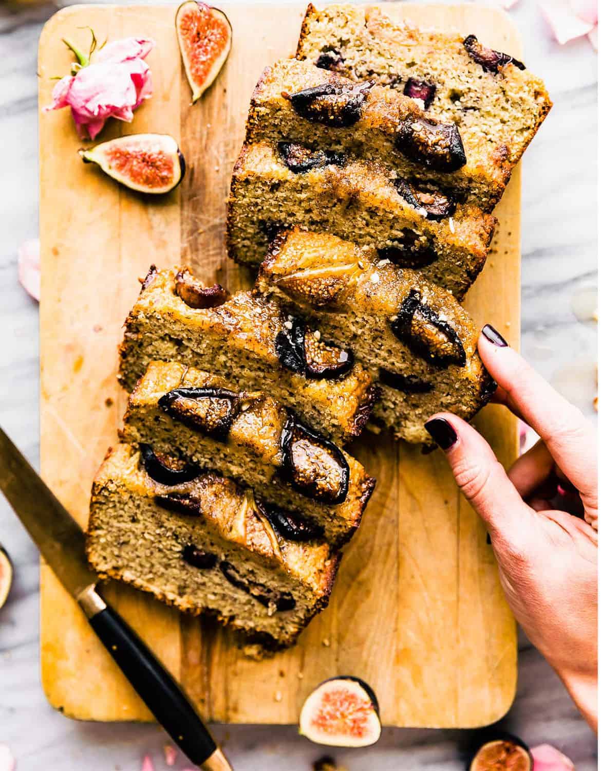 Seven slices of roasted fig loaf on a wooden chopping board - Cotter Crunch