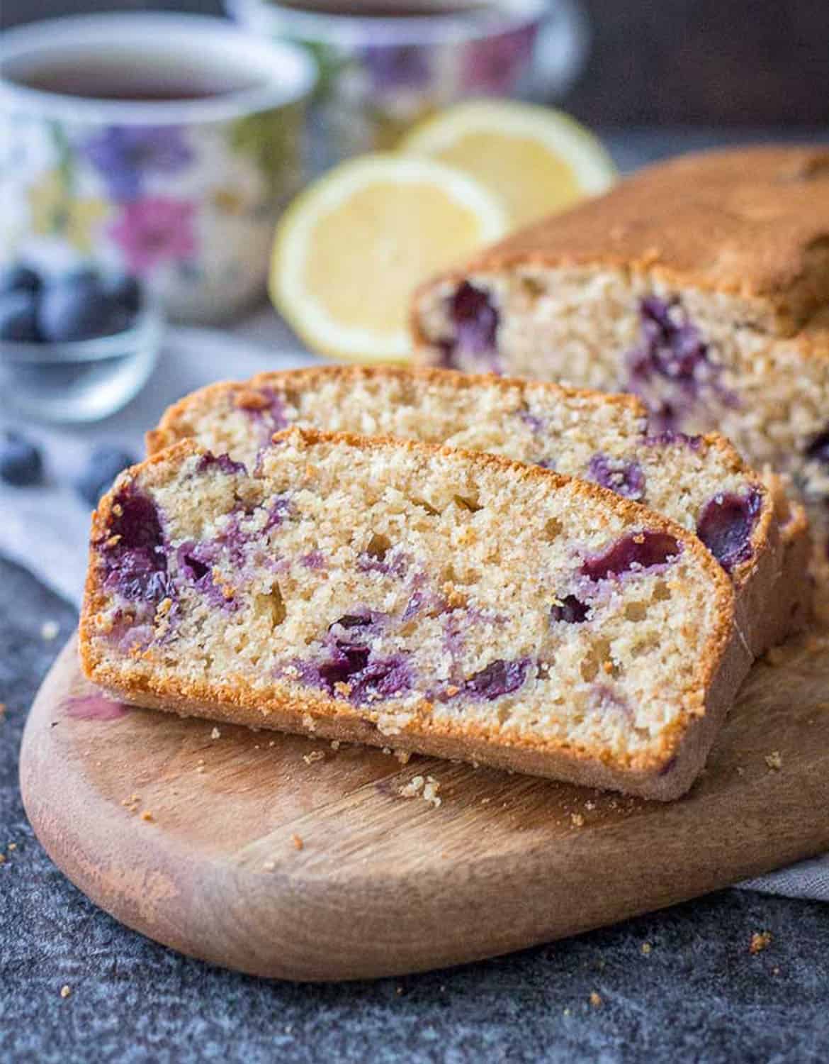 Slices of lemon blueberry pound cake on a wooden chopping board - Natalie's Health