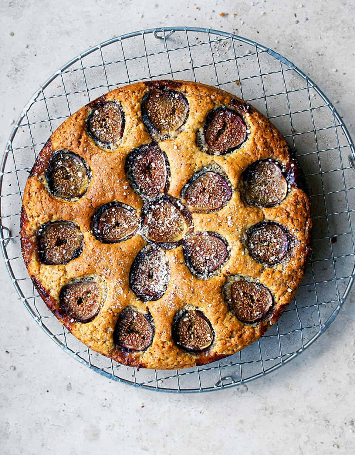 A round cake with figs over a grey background - Occasionally Eggs