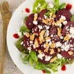 Beetroot salad with feta over a white serving plate.