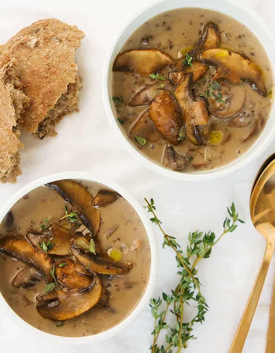 Two bowls of mushroom soup decorated with mushrooms and fresh thyme - The Clever Meal