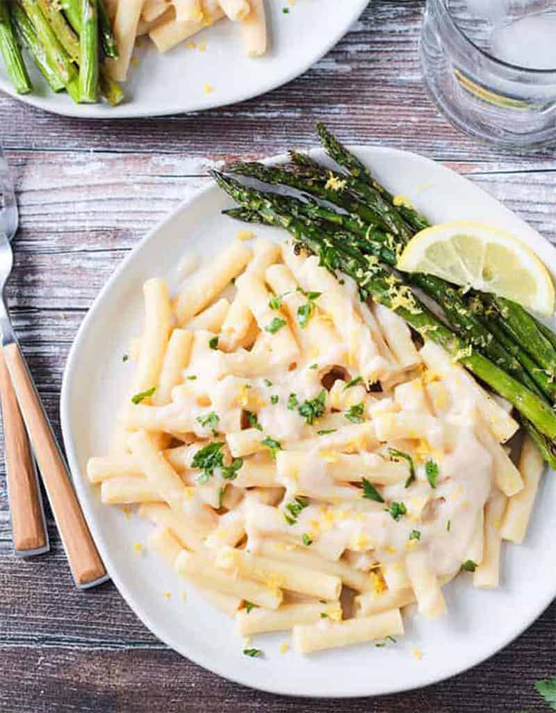 Creamy lemon pasta with asparagus on a white plate - Veggie Inspired