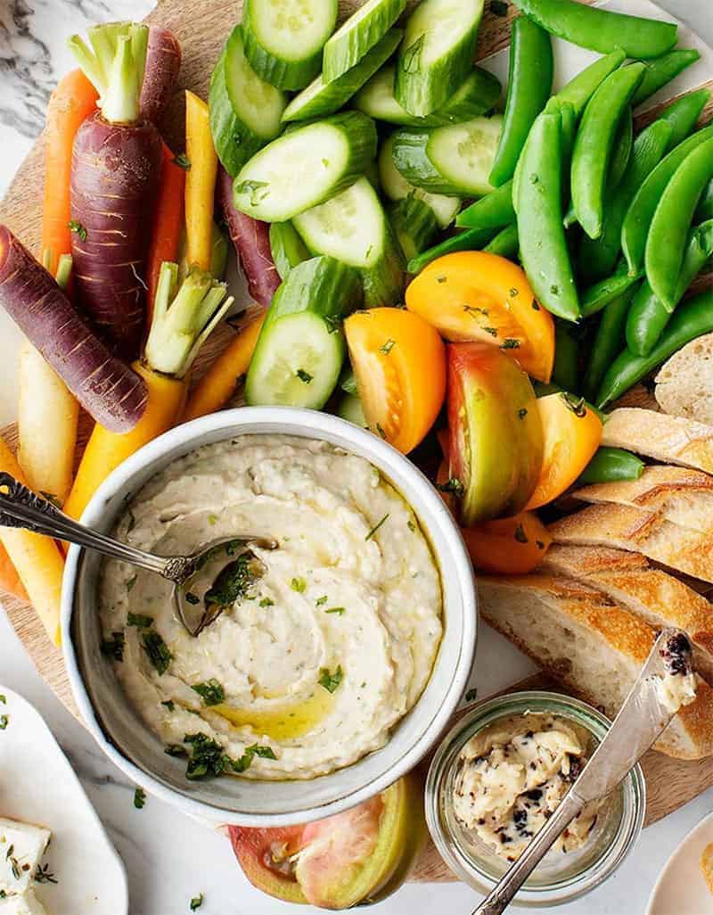 Cannellini bean hummus with crudités on a serving tray - by Love & Lemons