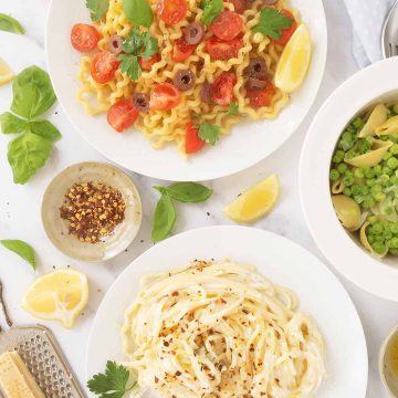 Three white plates with different quick pasta recipes over a white table.