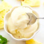 Top view of a white bowl full of pineapple sorbet.