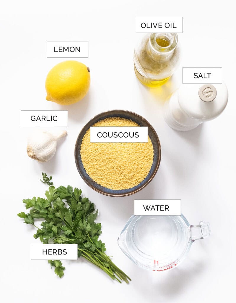 The ingredients for this lemon couscous salad are arranged on a white surface.