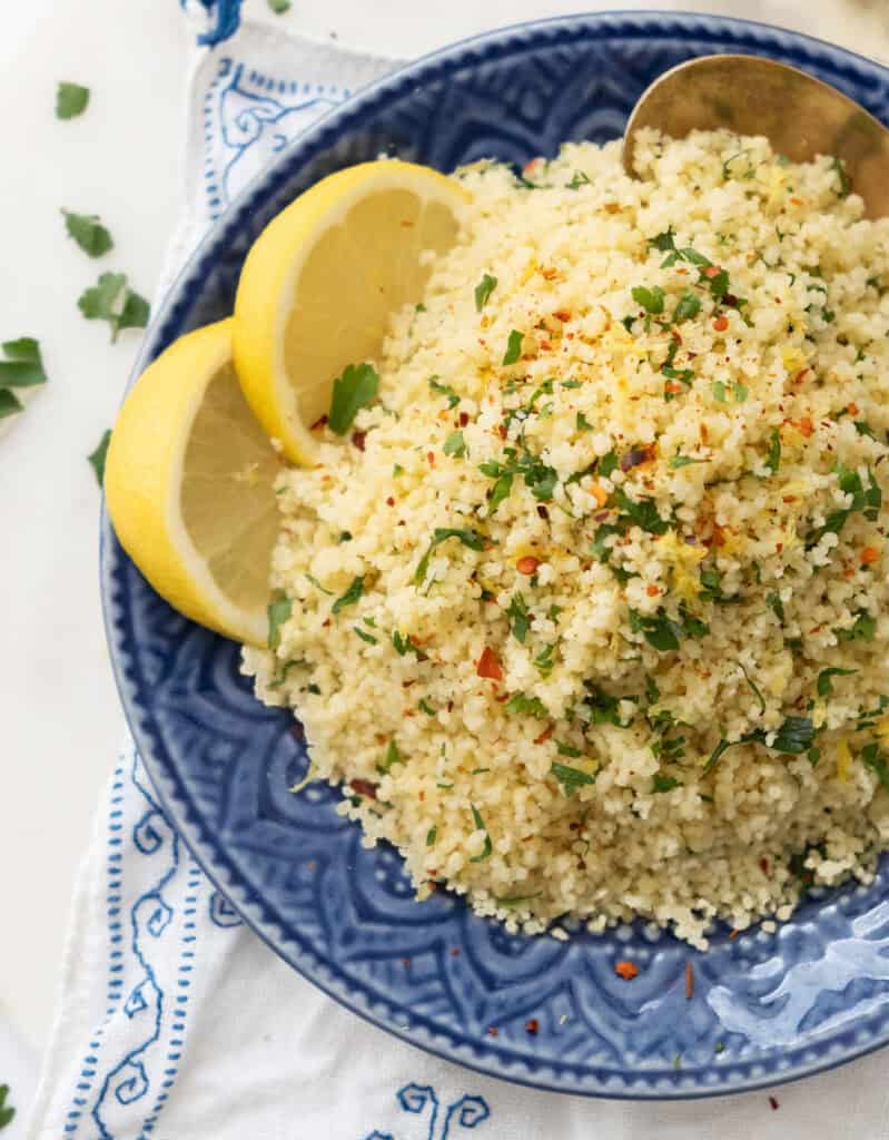 Close-up of a serving of lemon couscous on a blue plate.