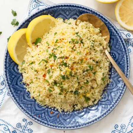 Top view of a serving of lemon couscous on a blue plate.