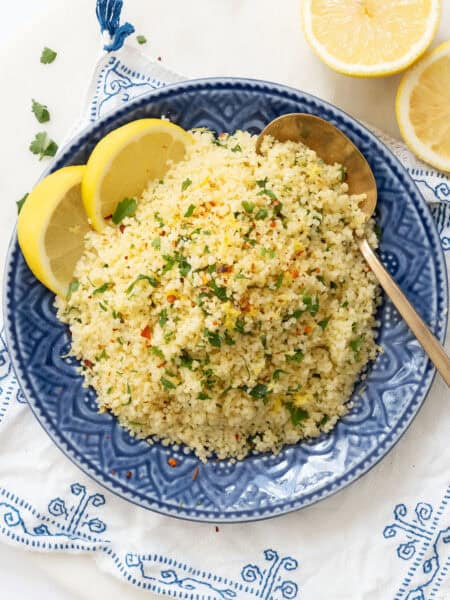 Top view of a serving of lemon couscous on a blue plate.