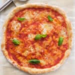 Top view of a round easy pizza with tomato and mozzarella.