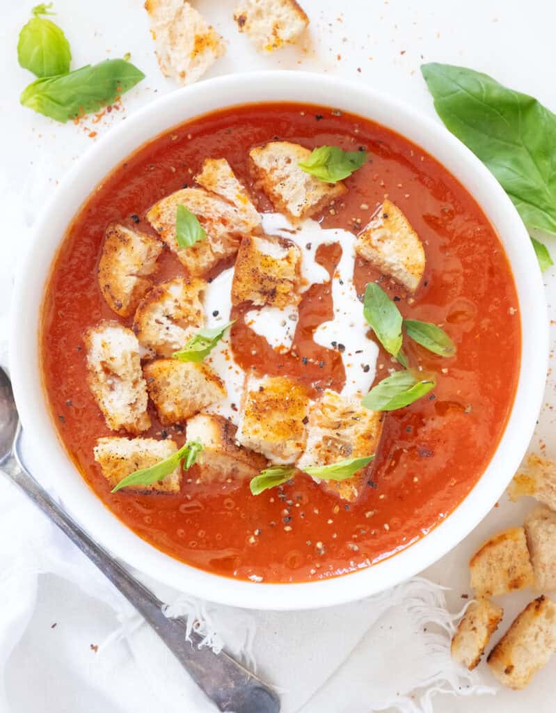 Top view of an easy tomato soup in a white bowl.