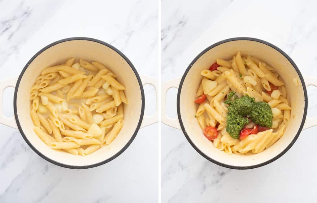 Top view of a white Dutch oven full of penne potatoes, cherry tomatoes and basil pesto.