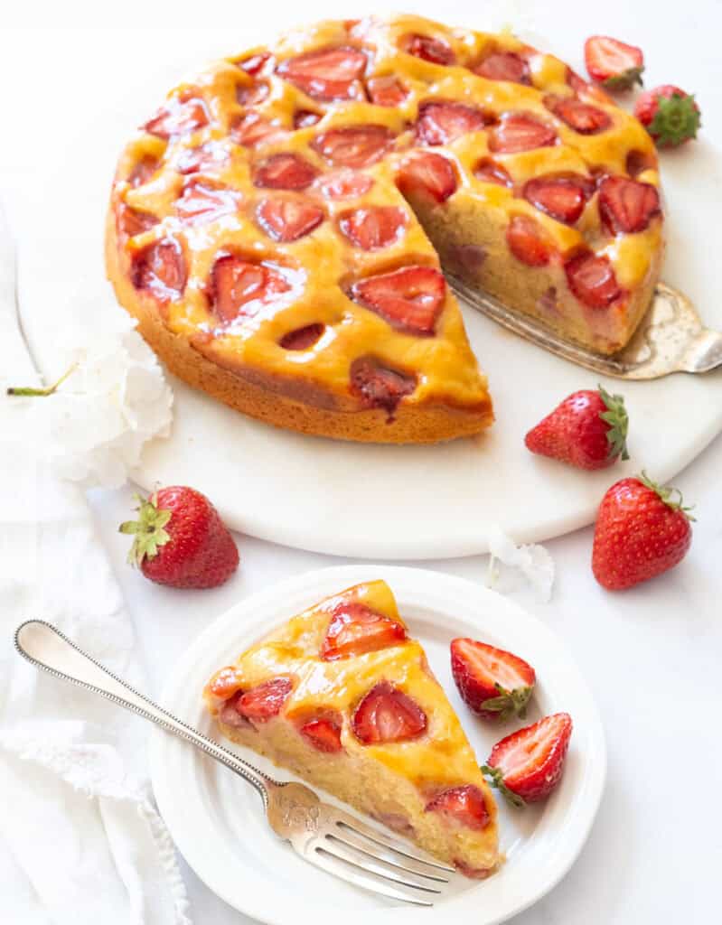 A strawberry ricotta cake slice over a white background.