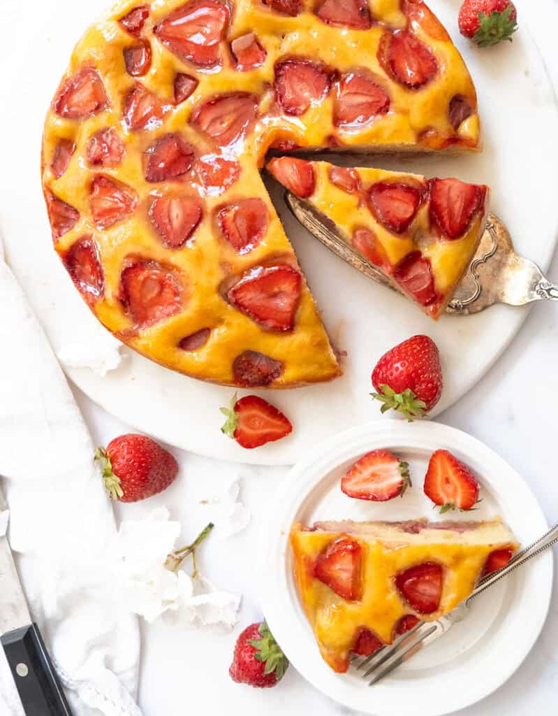 Top view of a strawberry ricotta cake cut into slices.