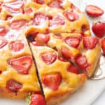 A ricotta strawberry cake cut into slices.