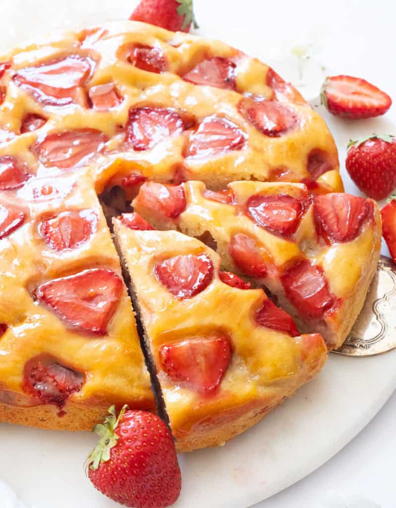 Close-up of a strawberry ricotta cake cut into slices.