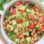 Top view of a white salad bowl full of barley salad.