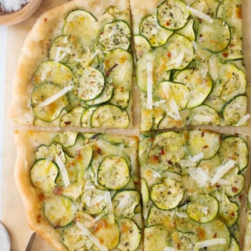 Top view of a crispy pizza with zucchini cut into slices.
