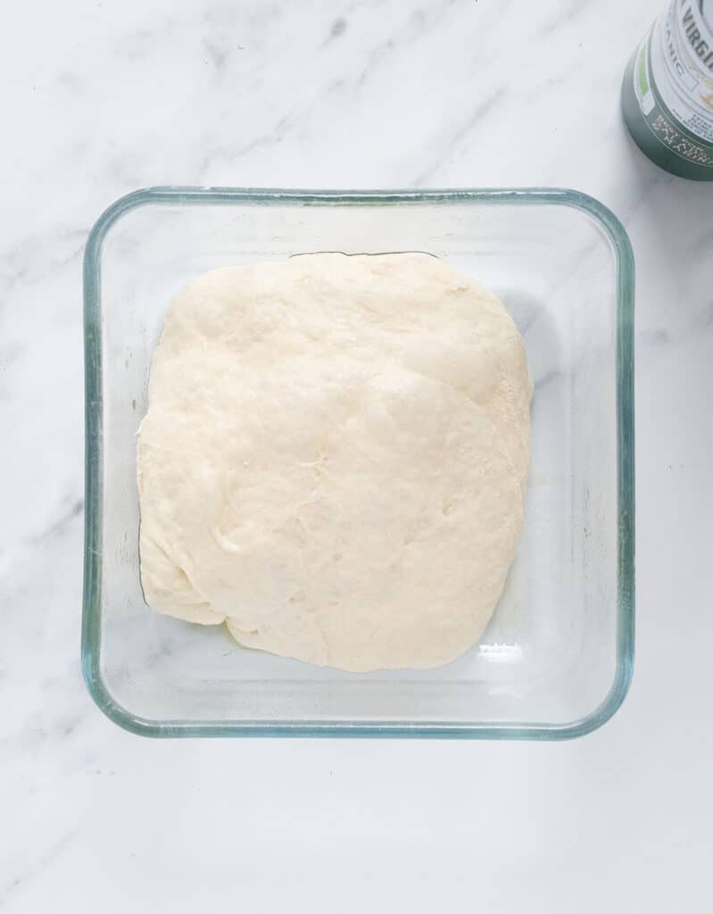 Top view of an airtight container with the easy dough ready to be frozen.