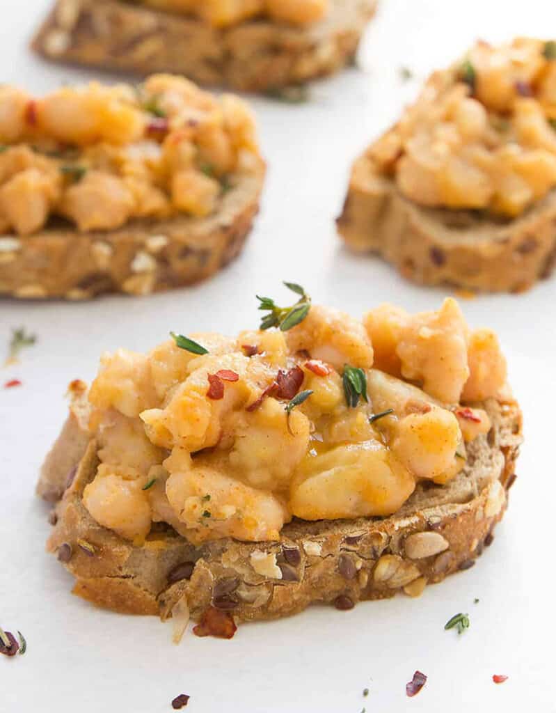 Crostini with cannellini beans on white background.