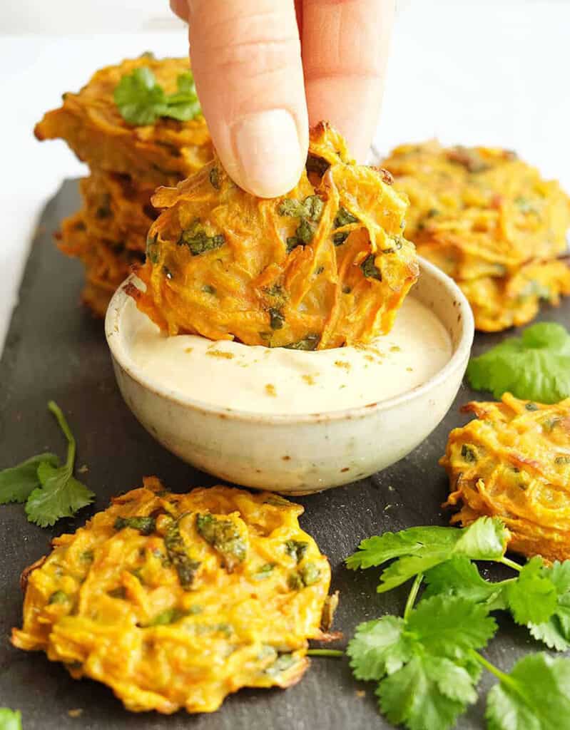 Carrot fritters with coriander and a small bowl with hummus dipping sauce are another brilliant party food idea.