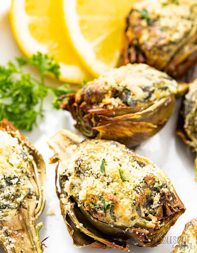 Close-up of a few artichoke halves crispy and coated with breadcrumbs and herbs.