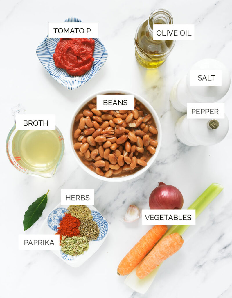 The ingredients to make this pinto soup are arranged over a white background.