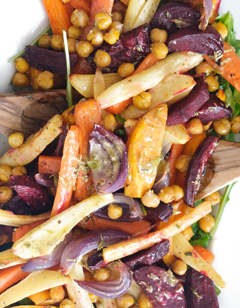 Close-up of some winter veggies with roasted root vegetables covered in mustard dressing.