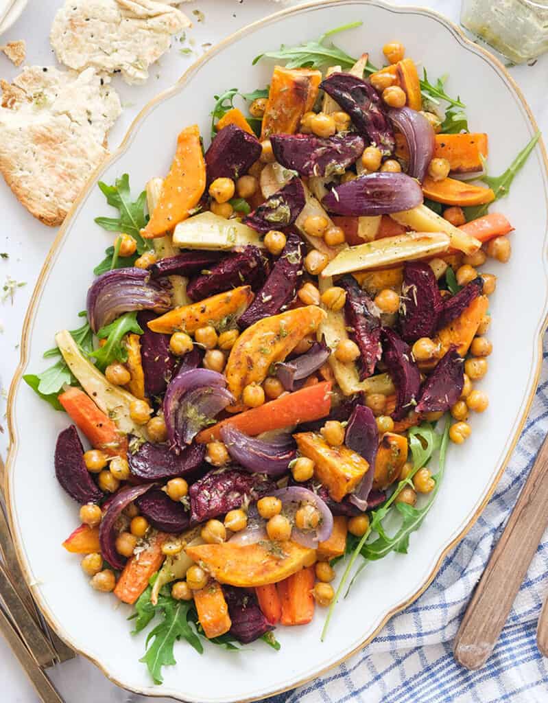 Top view of a salad tray full of chickpea and roasted root vegetable salad.