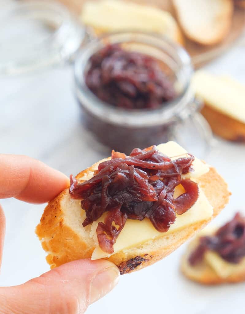 Close-up of crostini with cheese and onion chutney.