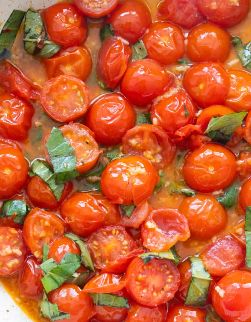 Close-up of cooked cherry tomatoes the look saucy and delicious.