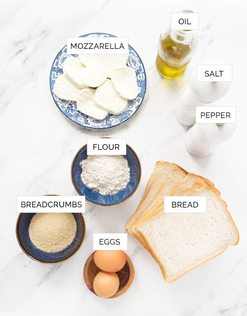 The ingredients to make these fried mozzarella in carrozza sandwiches are arranged over a white background.