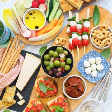 Top view of a table full of colorful Italian appetizers.
