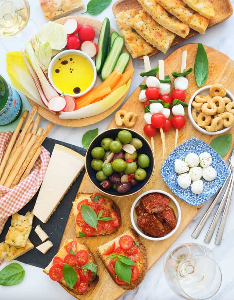 Top view of a table full of colorful Italian appetizers.