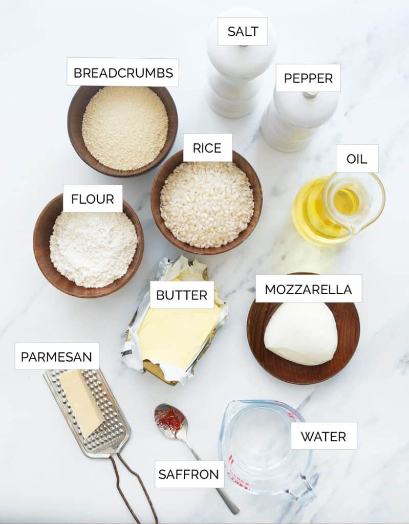 The ingredients to make these Italian rice balls are arranged over a white background.
